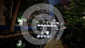 Beautiful Riverwalk in San Antonio with its small restaurants and pubs along the river - view by night