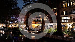 Beautiful Riverwalk in San Antonio with its small restaurants and pubs along the river - view by night - SAN ANTONIO