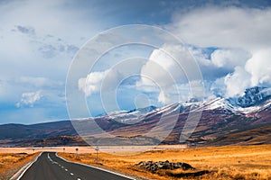 Beautiful road in autumn mountains. Chuysky tract in Altai, Siberia, Russia