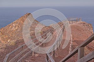 Beautiful road with wooden railing leading to a viewpoint next to the volcanic mountain, Fuerteventura