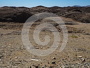 Beautiful rock mountain texture landscape background of Namib desert unique geography with splitting stone ground and desert plant