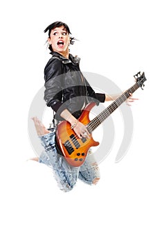 Beautiful rock-n-roll girl jumping with guitar photo