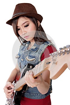 Beautiful rocker girl playing her electric guitar, on white back