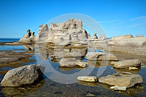 Beautiful rocks and his reflexion in water at grande ile in Mingan in Quebec