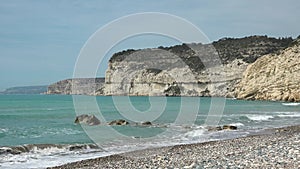 Beautiful rocks and waves on the ocean. Beautiful coastline with turquoise water. Aphrodite's rock a famous tourist
