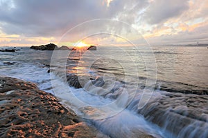 Beautiful rocky beach illuminated by the golden rays of morning sunlight at Yehliu Coast, Taipei, Taiwan