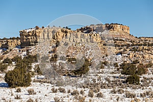 Beautiful rocky mountain formation with snow covered desert vista in rural New Mexico