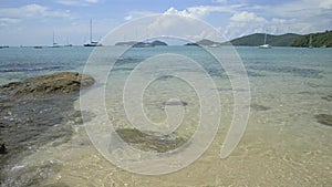 Beautiful rocky and sandy beach with clear water under cloudy blue sky, Phuket, Thail