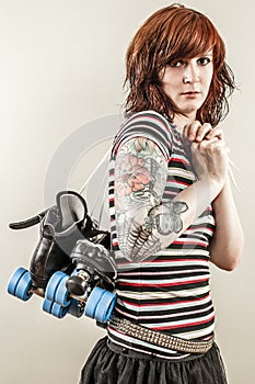 Beautiful roller derby woman holding skates