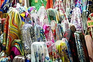 Beautiful rolls of colorful fabric and textiles in the shop