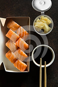 Beautiful rolls and sushi and california roll on dark table. Food delivery. Lunch. Food at home.