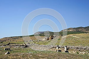 Beautiful Roman ancient ruins of hierapolis Pamukkale with meadow field