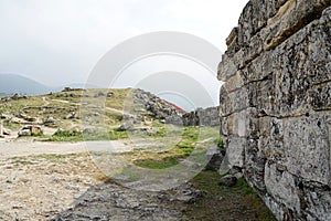 Beautiful Roman ancient ruins of hierapolis Pamukkale with meadow field