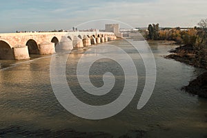 The beautiful Roman bridge over the river Guadalquivir leading to the town of Cordoba in Andalusia photo