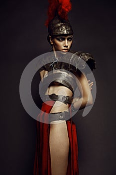 Beautiful Roman woman in armour and helmet