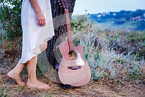 Beautiful romantic background with guitar outdoor. Photo of sensual woman. Art work. Music background download