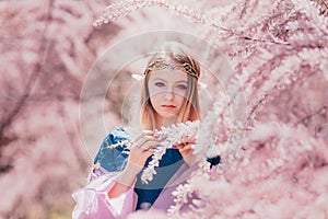 Beautiful romantic blonde girl with blue eyes posing in forest. Dreaming fairytale girl. Cosplay character