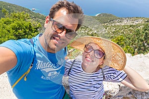 Beautiful, romantic caucasian couple taking selfie self portrait photo on summer vacations on Adriatic coast of Croatia