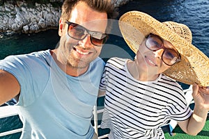 Beautiful, romantic caucasian couple taking selfie self portrait photo on summer vacations traveling by cruse ship ferry