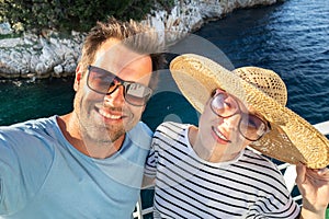 Beautiful, romantic caucasian couple taking selfie self portrait photo on summer vacations traveling by cruse ship ferry
