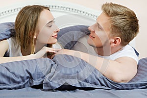 Beautiful romantic couple in bed, happy relationship, heterosexual couple