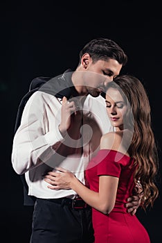 beautiful romantic couple in formal wear hugging isolated