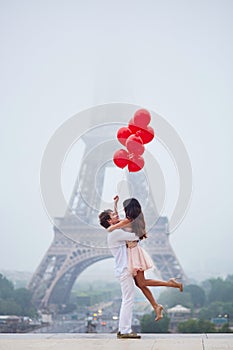Beautiful romantic couple near the Eiffel tower in Paris