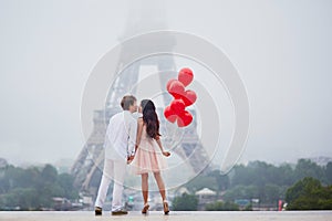 Beautiful romantic couple near the Eiffel tower in Paris