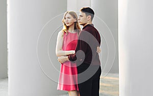 Beautiful romantic couple, woman in a dress and a handsome man are hugging and looking at each other. Valentine`s Day