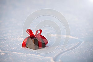 Beautiful romantic gift box on a white snow.
