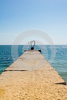 Beautiful romantic love background, silhouette of affectionate couple on the pier at sunset