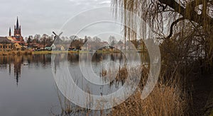 The small town of Werder on the Havel. In the foreground the river with trees. photo