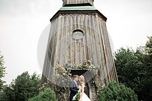 Beautiful romantic wedding couple of newlyweds hugging near old castle