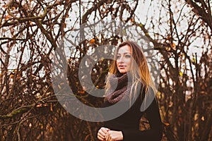 Beautiful romantic woman on a walk in autumn. Woman with healthy long hair.