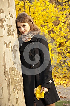 Beautiful romantic young girl in an autumn park