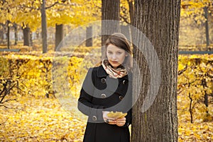 Beautiful romantic young girl in an autumn park