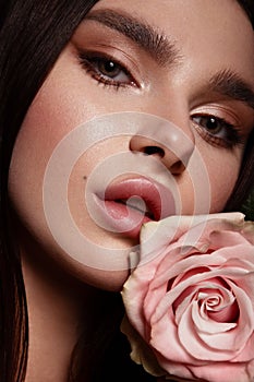 Beautiful romantic young woman with rose. Inspiration of spring and summer. Perfume, cosmetics concept.