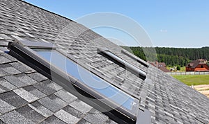 Beautiful roof windows and skylights against blue sky photo