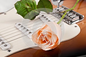 Close-Up of Rose Flower with Dew Drops on Electric Guitar: Love and Romantic Concept Image