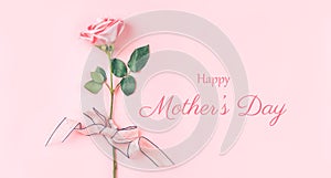 Beautiful rose of pink color against a pink background. Photo caption happy mother`s day. Greeting card