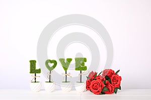 Beautiful roses with word LOVE