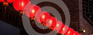 Beautiful round red lantern hanging on old traditional street, concept of Chinese lunar new year festival