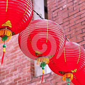 Beautiful round red lantern hanging on old traditional street, concept of Chinese lunar new year festival, close up. The undering