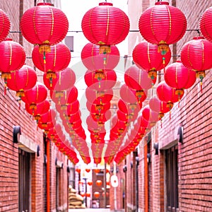 Beautiful round red lantern hanging on old traditional street, concept of Chinese lunar new year festival, close up. The undering