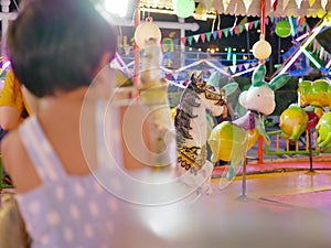 Beautiful roundabout at a fair with a defocus little Asian baby girl in a foreground