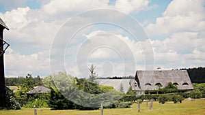 Beautiful Rural Landscape with a Farm House and Big Wooden Windmill in Summer