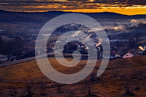 Beautiful rural scene with a village in a valley surrounded by s