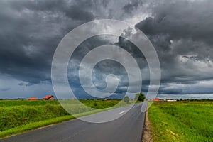 Beautiful rural scenery with bright green foliage and storm clouds