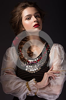 Beautiful Russian girl in national dress with a braid hairstyle and red lips. Beauty face.