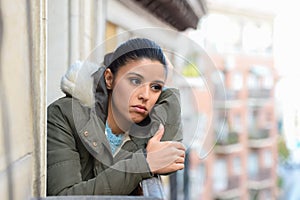 Beautiful sad desperate hispanic woman in winter coat suffering depression